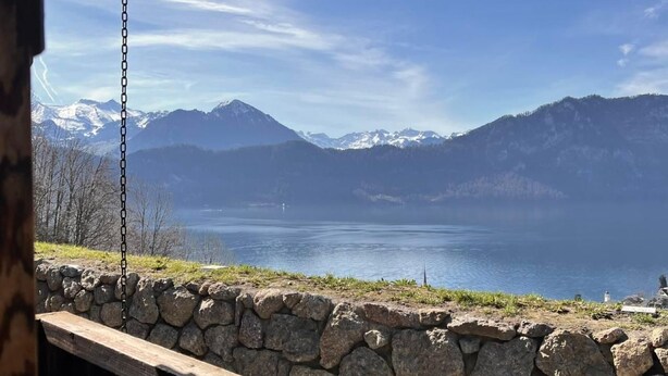 A stone wall with a wooden bench overlooking a lake and mountains. - SPYCHER WEGGIS by Interhome (Weggis)