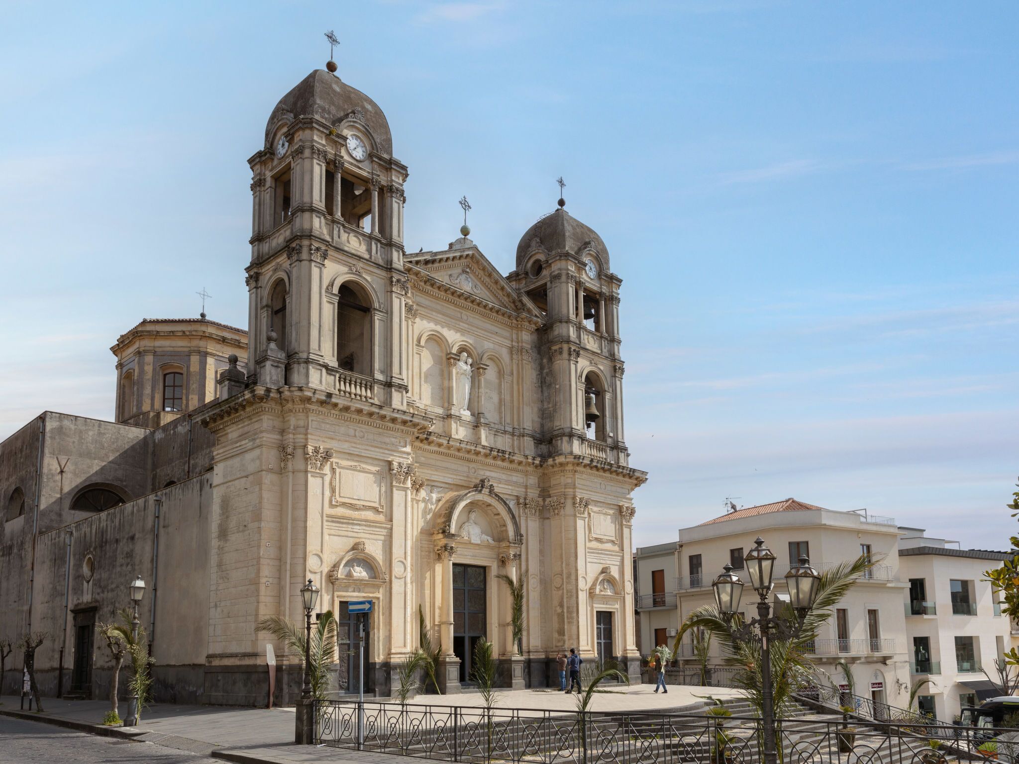 A historic church with a central dome and two bell towers, featuring classical architecture and a large entrance.