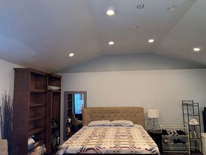 A bedroom with a bed, a wardrobe, a television, and a shoe rack. - Cozy 1-bedroom studio in charming Los Angeles with AC (Los Angeles)