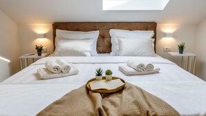 A neatly made bed with white linens, a brown headboard, and a skylight above. - "Villa Tango" by Interhome (Trogir/Okrug Donji)