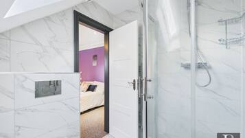 Shower, hair dryer, towels, toilet paper