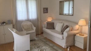 A living room with a sofa, two chairs, a small table, a lamp, a mirror, and a cabinet. - Chesa Lodola by Interhome (Madulain)
