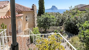 A terrace with a view of the sea, a stone building, and a metal railing. - Villa Marie by Interhome (Calpe/Calp)