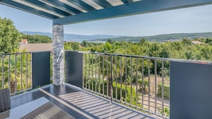 A balcony with a view of a green landscape and distant hills. - Haus Dragica by Interhome (Krk/Čižići)