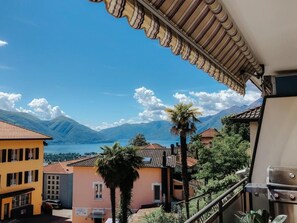 A balcony with a view of mountains and a lake. - What a view by Interhome (Orselina)