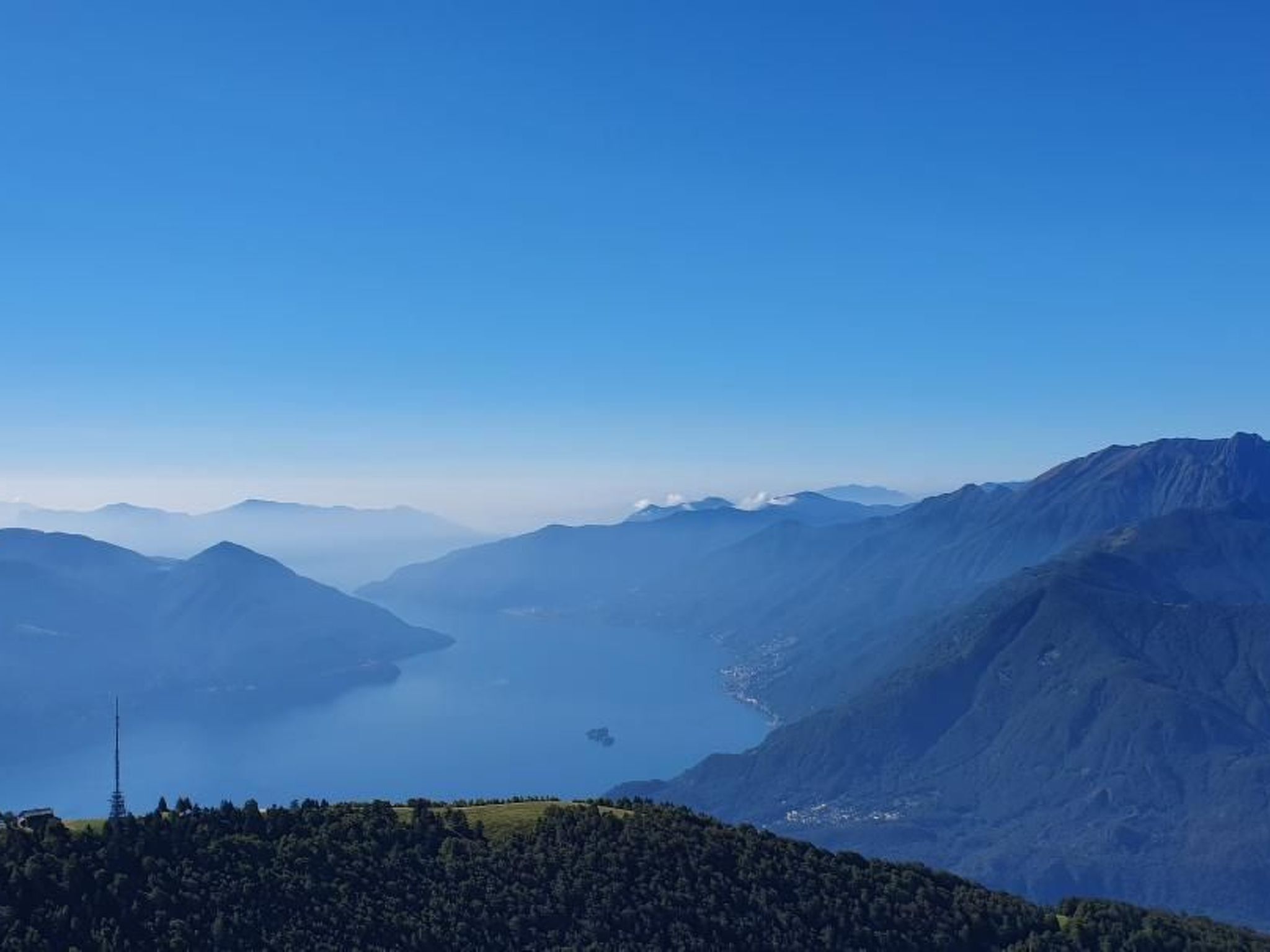A mountainous landscape with a clear sky and a lake.