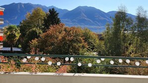 A balcony with a view of mountains and trees. - Casa delle Vigne by Interhome (Minusio)