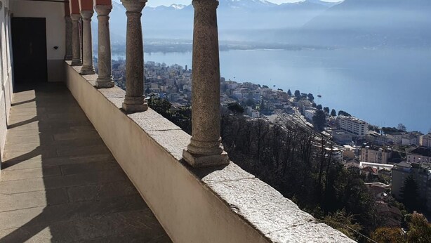 A balcony with stone columns overlooking a city and a lake, with mountains in the distance. - Casa delle Vigne by Interhome (Minusio)