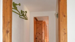 A wooden hallway with a door at the end. - Bos-cha by Interhome (La Punt-Chamues-ch)