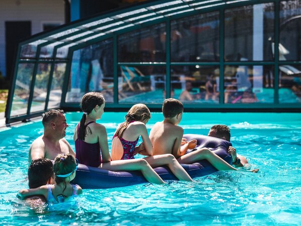 A swimming pool with people lounging on inflatable tubes. - for 5 people by Interhome (Rusinowo)