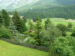 A rural landscape with a house surrounded by lush greenery and a mountain backdrop. - Chesa Cuntainta by Interhome (St. Moritz)