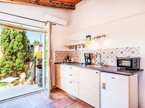 A modern kitchen with a built-in oven, a coffee maker, and a refrigerator. - Juniorsuite by Interhome (Son Gall Vell)