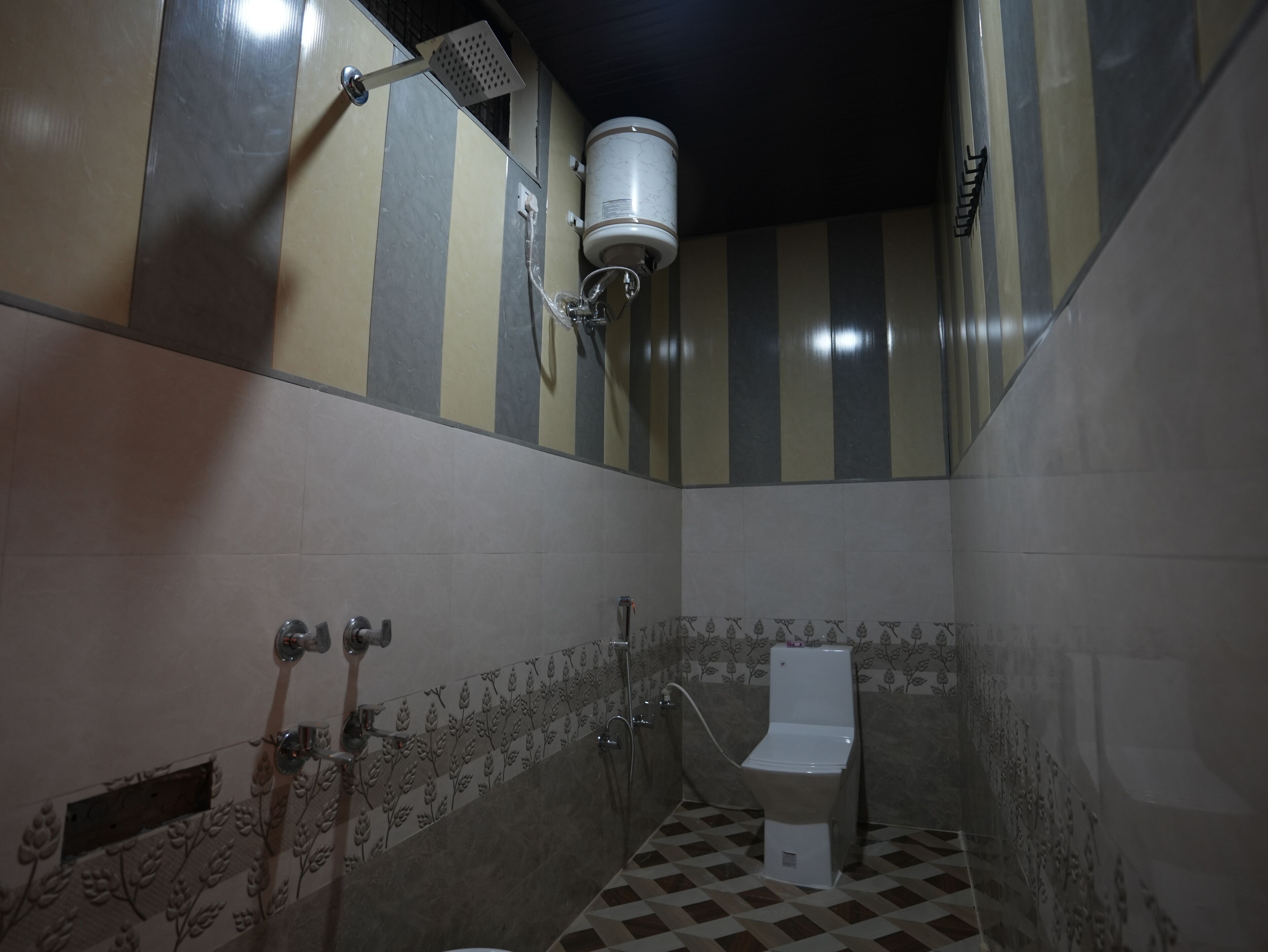 A small bathroom with a toilet, a shower, and a water heater.