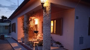 A house with a covered porch, potted plants, and a staircase leading to the entrance. - Haus in Pula mit privatem Pool by Interhome (Pula)
