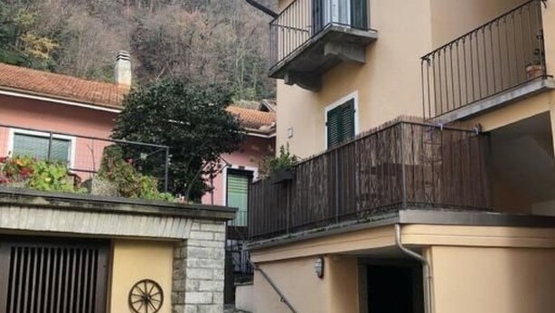 A two-story building with a balcony, a staircase, and a bicycle parked outside. - Zwischen Locarno und Ascona ganze Wohnung by Interhome (Locarno)