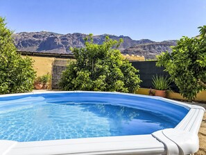 A swimming pool with a mountain backdrop. - "La Almendra" mit Terrasse by Interhome (San Bartolomé de Tirajana)