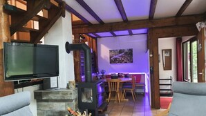 A cozy living room with a fireplace, a television, and comfortable seating. - Waldhaus57 Silbersee by Interhome (Frielendorf)