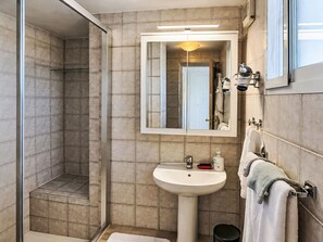 A bathroom with a shower, sink, and mirror. - Apartment El Hierro by Interhome (El Paso)