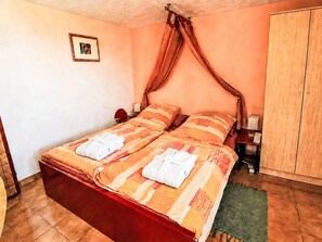A double bed with a canopy, two bedside tables, a nightstand, and a wardrobe. - Apartment El Hierro by Interhome (El Paso)