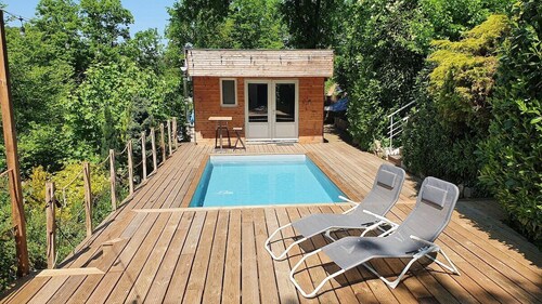 Chalet with swimming pool in a green setting