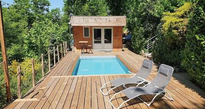 Chalet with swimming pool in a green setting
