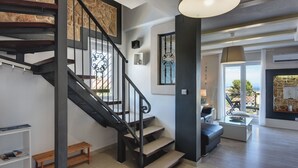 A modern interior with a staircase, a seating area, and a view of the outdoors. - mit Blick auf das Wasser by Interhome (Medulin/Ližnjan)