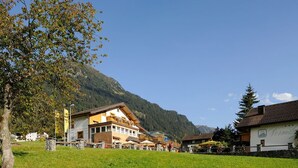 A mountain resort with a wellness center, outdoor seating, and a view of the surrounding hills. - Ruhiges Appartement in St. Gallenkirch by Interhome (Sankt Gallenkirch)