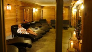 A spa room with wooden walls, multiple massage chairs, and candles. - Ruhiges Appartement in St. Gallenkirch by Interhome (Sankt Gallenkirch)