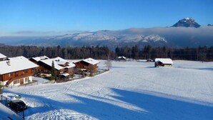 A snow-covered landscape with wooden cabins and a mountain in the background. - Pfrundmatte 12 by Interhome (Aeschi bei Spiez)
