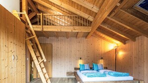 A wooden room with a loft bed, a ladder, and a nightstand. - Stöckli auf dem Birkenhof mit Zusatzzimmer by Interhome (Sörenberg)