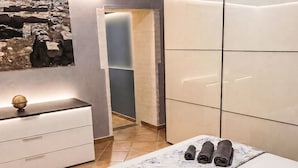 A modern bedroom with a bed, a nightstand, a dresser, and a wall-mounted globe. - 'Casa Donna Giovanna by Interhome (Chia)