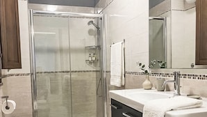 A modern bathroom with a glass-enclosed shower, a sink with a mirror, and a toilet. - 'Casa Donna Giovanna by Interhome (Chia)