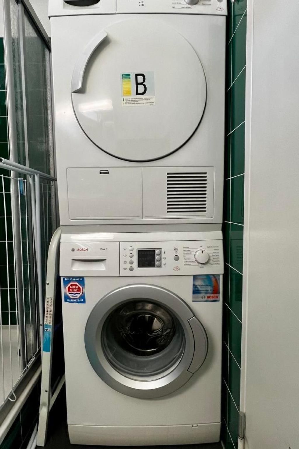 A stacked washer and dryer unit with a control panel and a circular door.