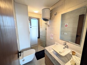 Een douche, een haardroger, een bidet, handdoeken