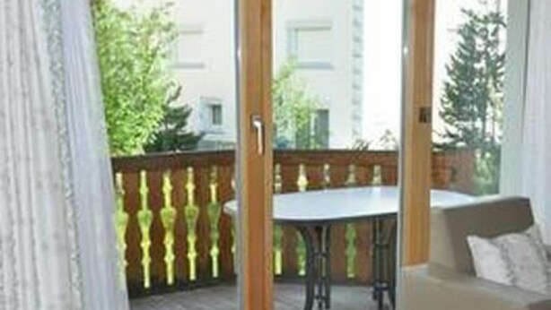 A room with a sliding glass door leading to an outdoor area with a table and chairs. - Apartment  by Interhome (Sils Maria)