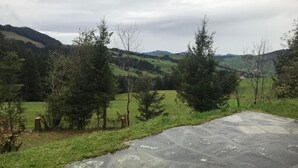 A paved area with a view of a green landscape and hills in the background. - Soldanella by Interhome (Appenzell)