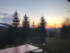 A table and chairs set outdoors with a sunset view. - Soldanella by Interhome (Appenzell)