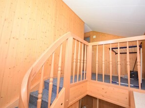 A wooden staircase with a carpeted landing. - Apartment West by Interhome (Lauterbrunnen)