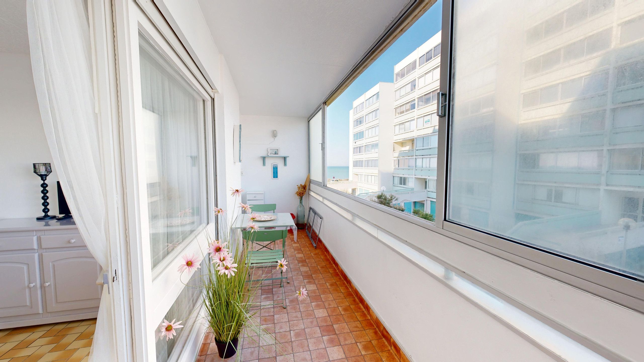 Ein schmaler Balkon mit Blick auf ein Gebäude gegenüber.