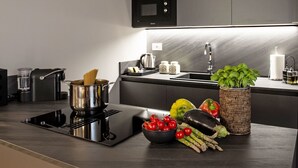 A modern kitchen with a built-in stove, a sink, and a microwave. - Cicerone Wohnung by Interhome (Bergamo)