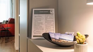 A hotel reception desk with a welcome sign, emergency number, and brochures. - Cicerone Wohnung by Interhome (Bergamo)