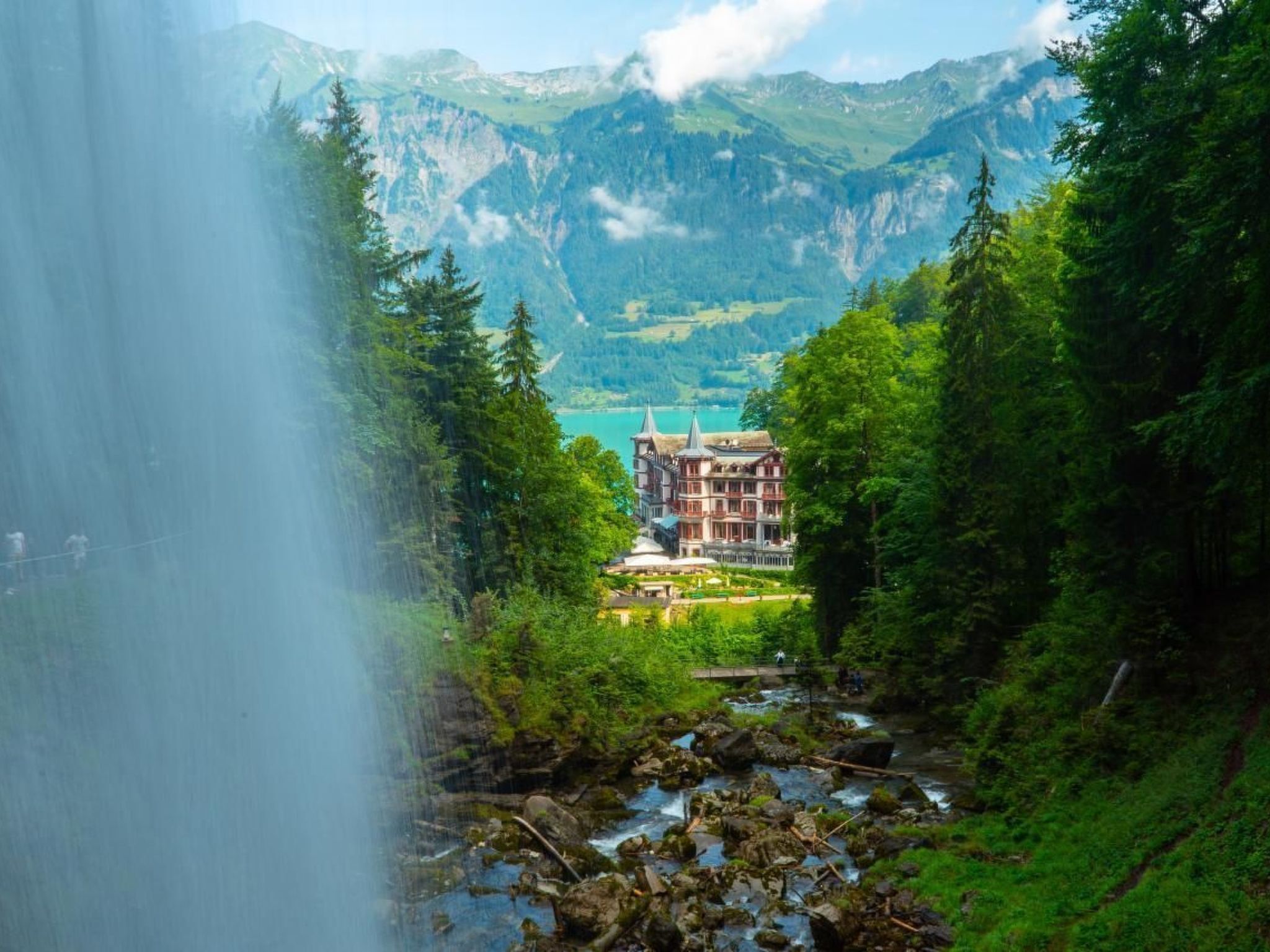 A mountain lodge with a view of a lake and mountains.