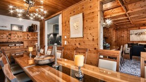 A wooden interior with a dining area, wooden cabinets, and a chandelier. - Luxus Alpenchalet Brigitta I by Interhome (Arosa)