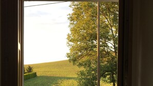 A view through a door of a grassy field with a tree and a fence. - Ferienvilla mit Terrasse, Grill und Garten by Interhome (Karlstejn)