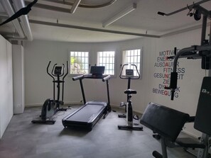 A gym with treadmills, elliptical machines, and weightlifting equipment. - Residenza Viramonte - Casa Fiona, Wohnung 52 by Interhome (Vira)