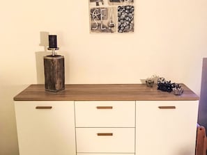 A kitchen counter with a wooden top, a metal object on it, and a wall with framed artwork. - Residenza Viramonte - Casa Daniela, Wohnung 31 by Interhome (Vira)