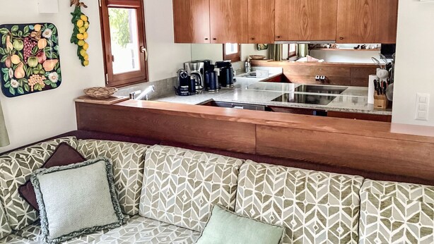 A compact kitchen with wooden cabinets, a built-in sink, and a countertop. - Sassella 2a by Interhome (La Punt-Chamues-ch)