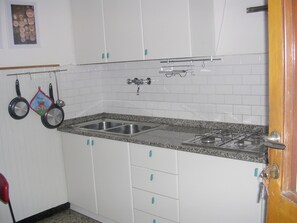 Fridge, stovetop, cookware/dishes/utensils, dining tables