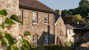A stone building with multiple windows and a sloped roof. - Upper School House (Newton Abbot)