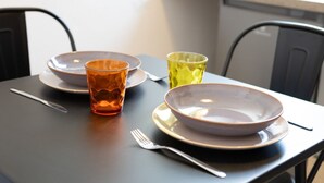 Et spisebord med to skåle, to glas, en gaffel og en kniv.